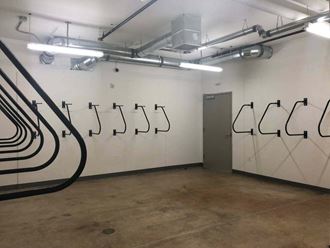 the wall of a room with hooks on the wall and a door