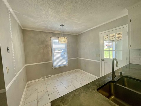 A kitchen with a sink and a window.