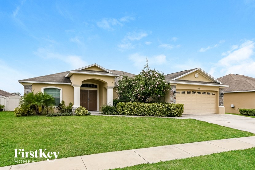 a house with a lawn and a driveway