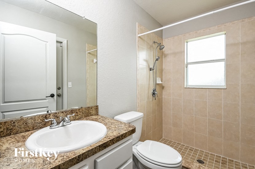 a bathroom with a sink toilet and a shower