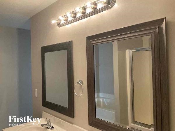 a bathroom with two mirrors and a sink