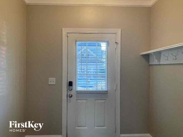 a white door and a window in a room