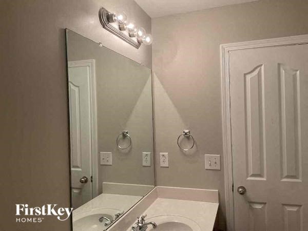 a bathroom with a white sink and a mirror