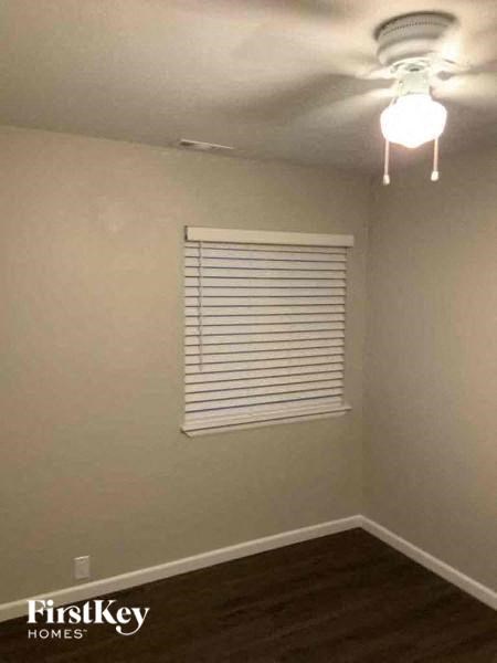 a empty room with a window and a ceiling fan
