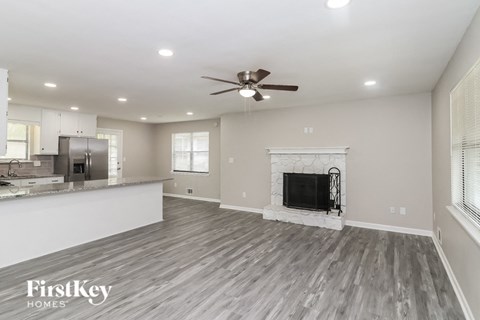 A spacious living room with a fireplace and a television.