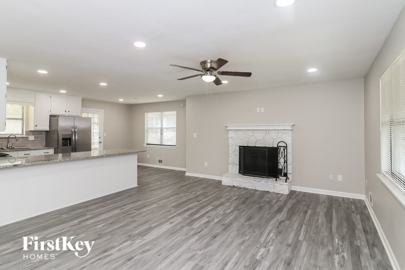 A spacious living room with a fireplace and a television.