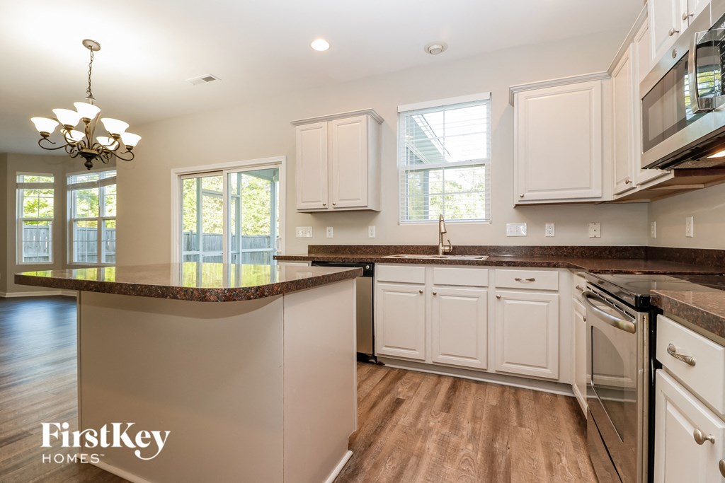 a kitchen with white cabinets and a counter top