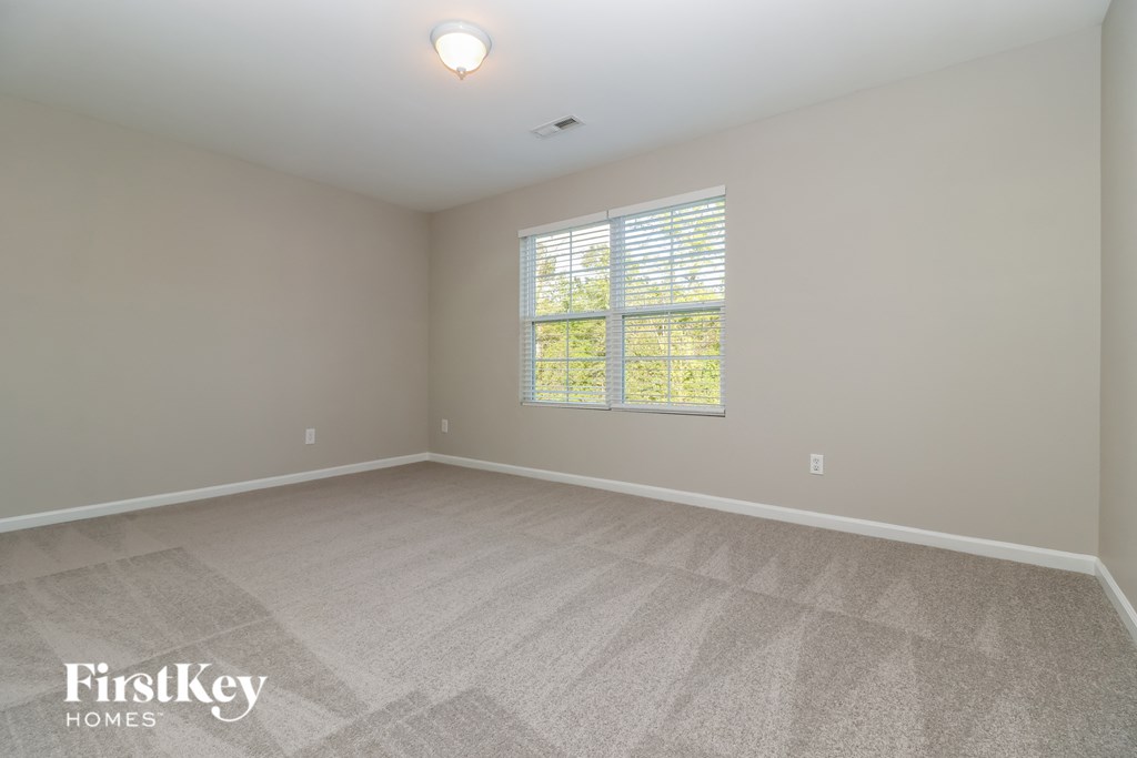 the living room of an empty house with a large window