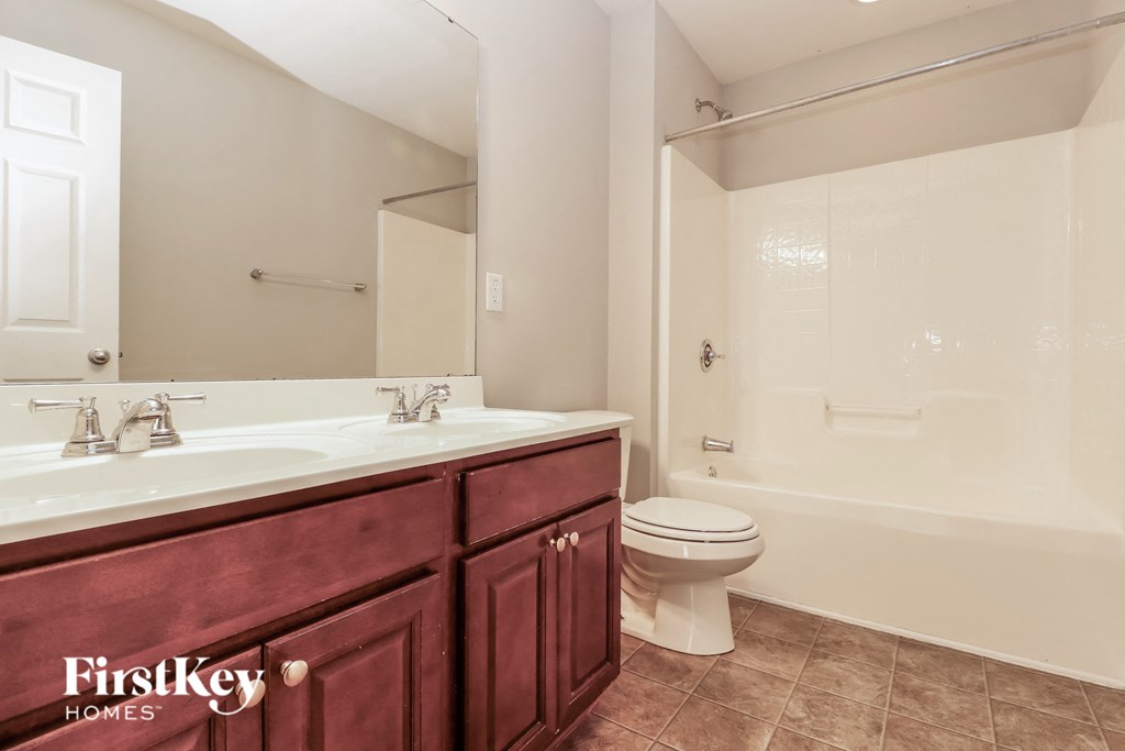 a bathroom with a sink toilet and a mirror