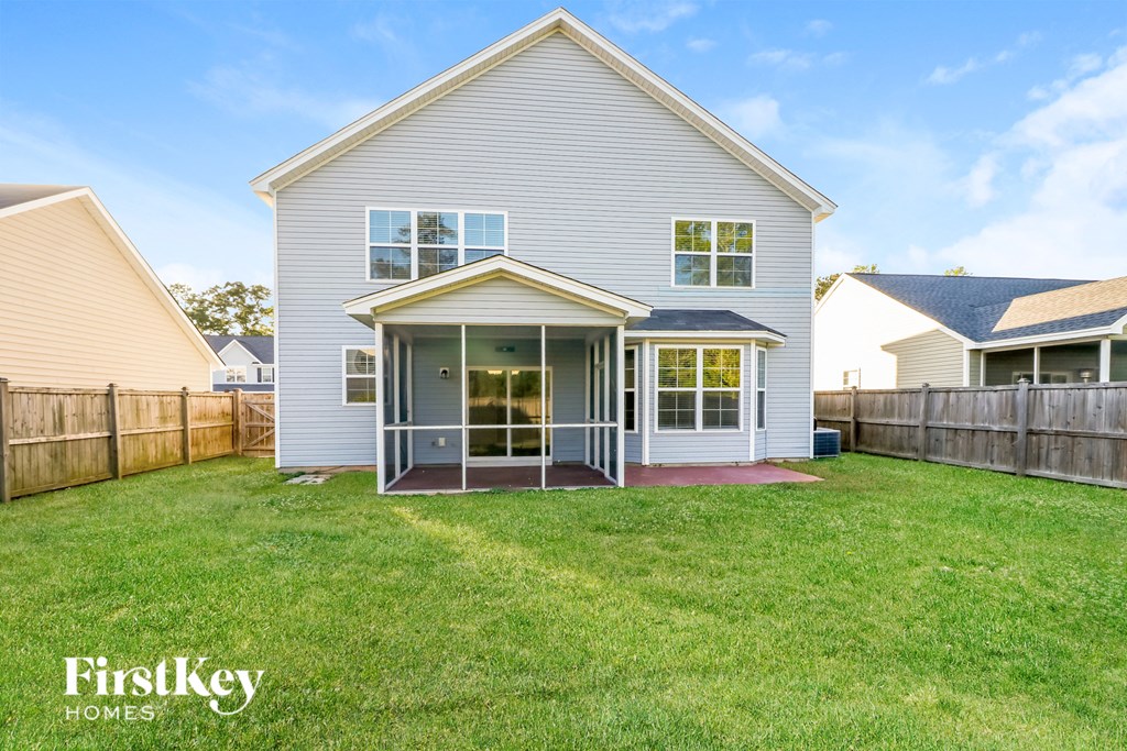 a white house with a yard in front of it