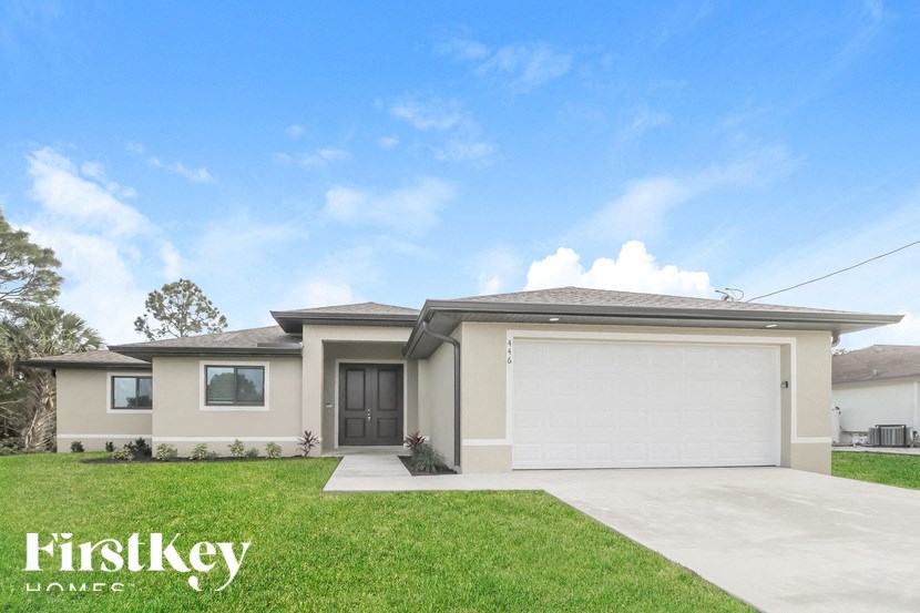 a brand new house with a garage door and a lawn