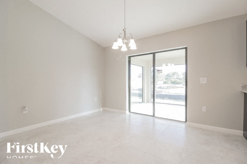 an empty living room with a sliding glass door to the patio