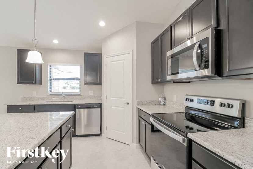 a modern kitchen with stainless steel appliances and granite counter tops