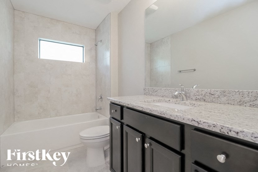 a bathroom with a sink and a toilet and a shower