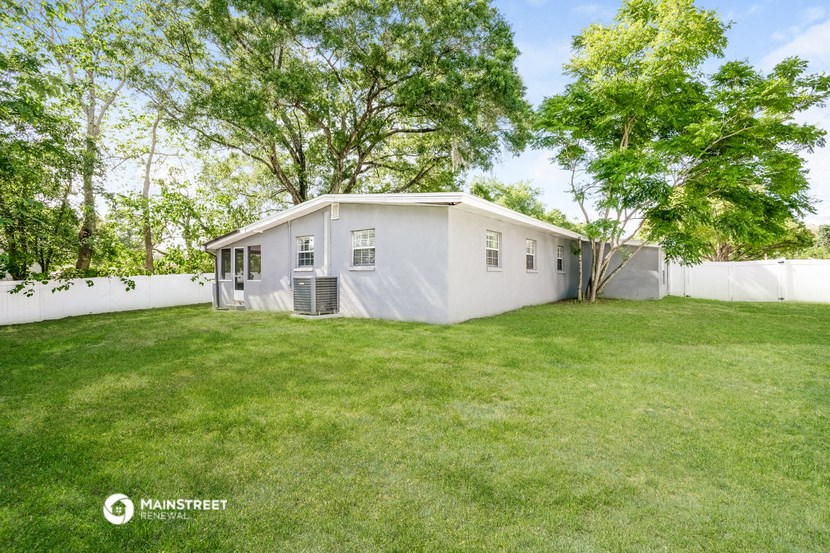 a white house with a yard and a white fence