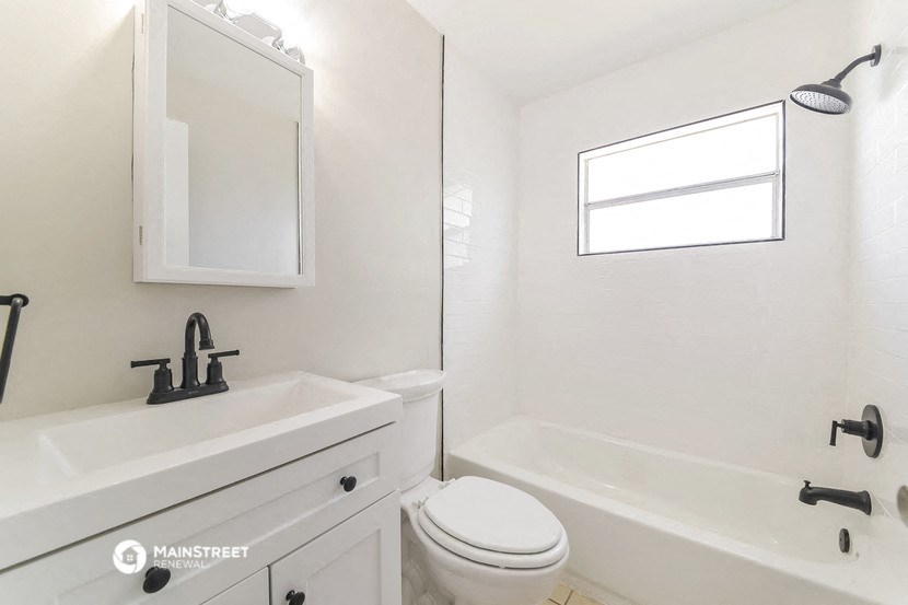 a white bathroom with a sink and a toilet