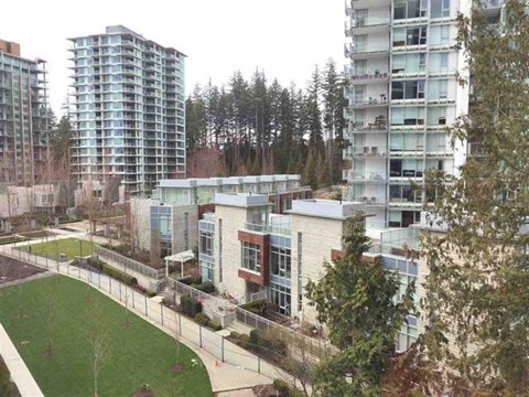 A modern building with a green lawn in front.