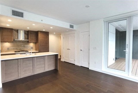 A kitchen with wooden cabinets and a white countertop.