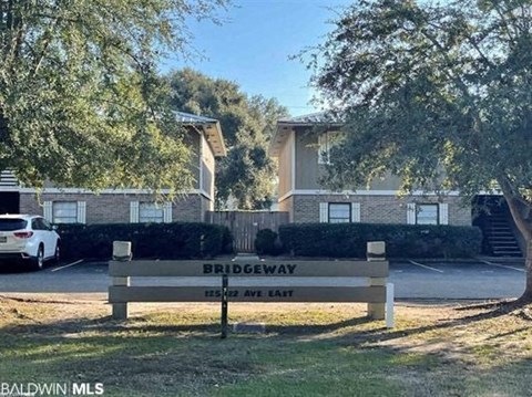 a bench in a park in front of a house