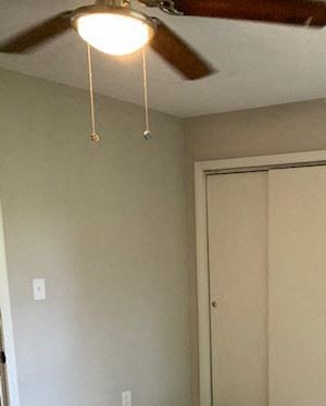 a living room with a wood floor and a ceiling fan