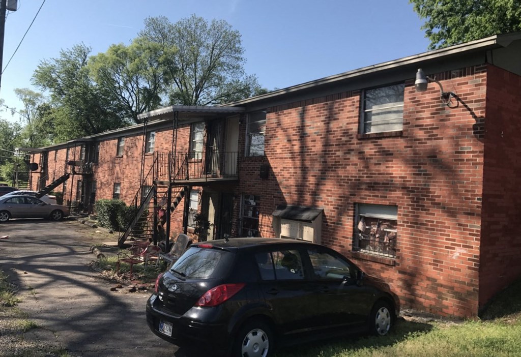 a car parked in front of a brick building