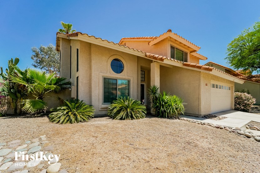 a house with a garage and a gravel driveway