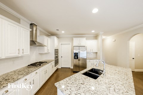 A kitchen with granite countertops and stainless steel appliances.