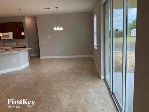 an empty kitchen and living room with sliding glass doors