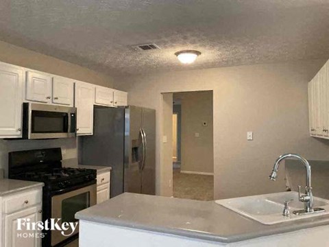 a kitchen with a sink a stove and a refrigerator