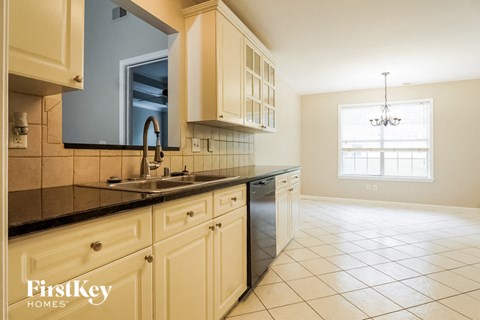 A kitchen with a sink and a window.