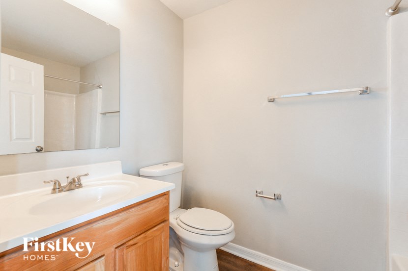 a bathroom with a toilet and a sink and a mirror