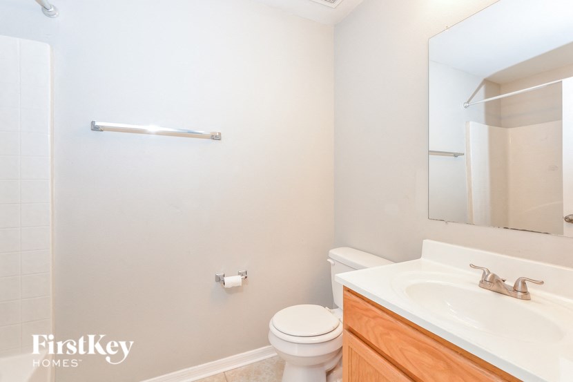 a bathroom with a sink toilet and a mirror