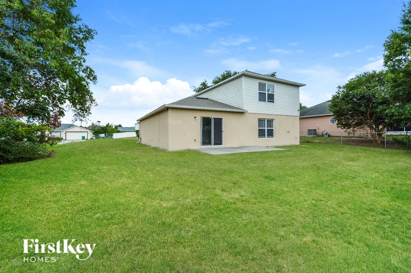 a home with a large yard and a white house