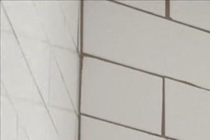 a white bathroom with a sink and a shower