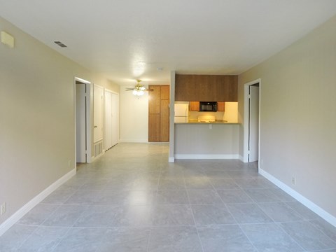 A spacious room with a ceiling fan and a light switch.