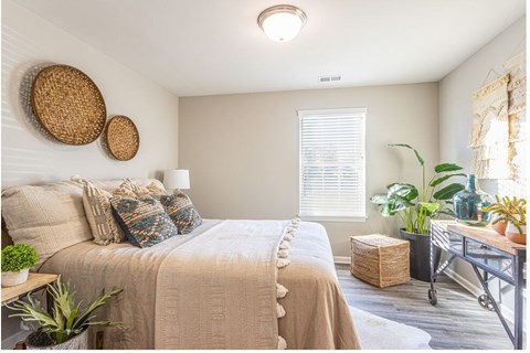 a bedroom with a bed and some baskets on the wall