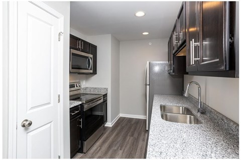 a kitchen with stainless steel appliances and granite counter tops