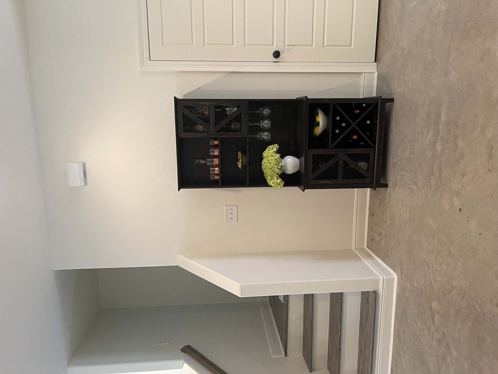 a cabinet with a drawer and a shelf above a staircase