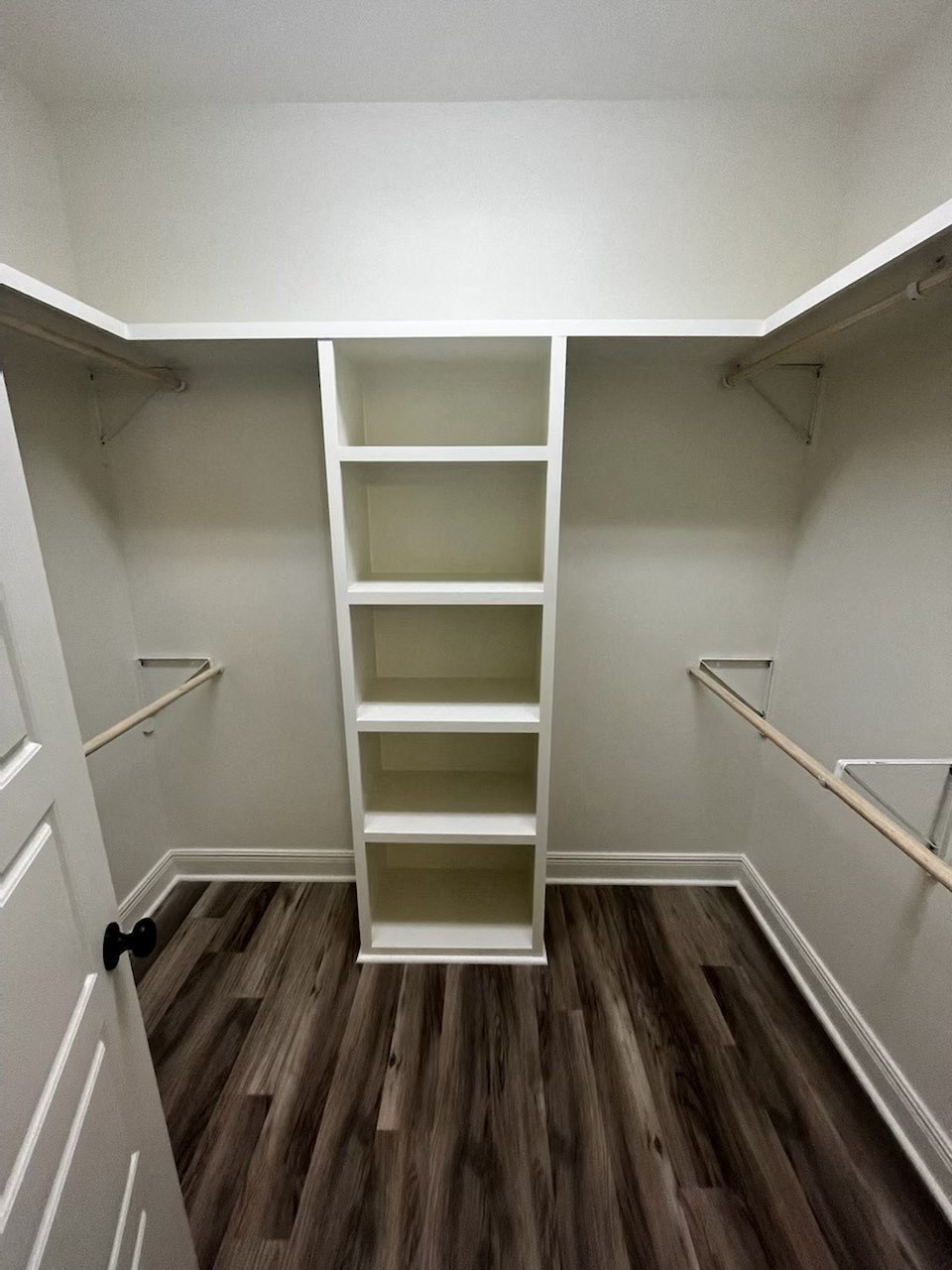 a walk in closet with shelves and a ladder