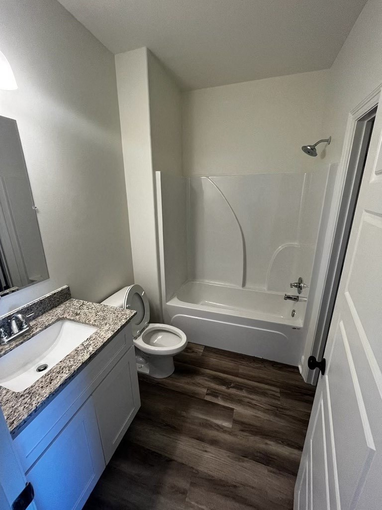 a bathroom with a toilet and a sink and a bath tub