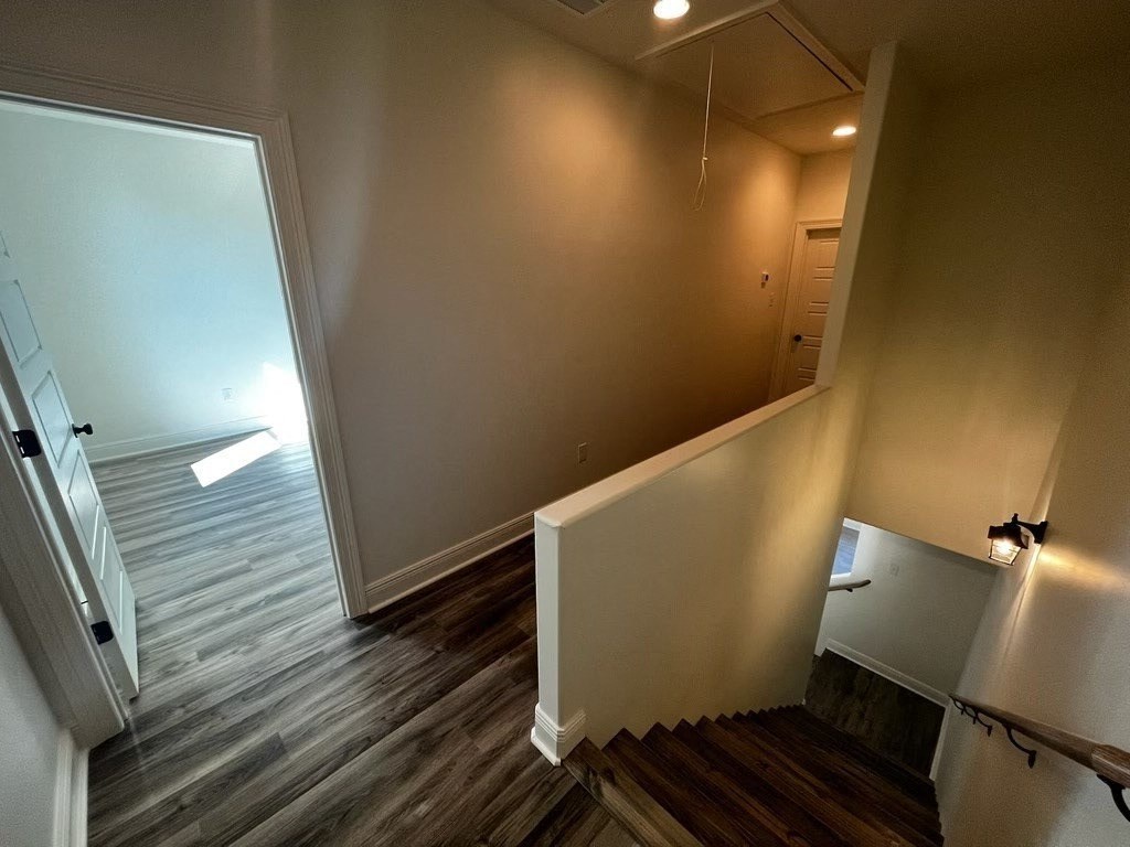 a view from the top of a staircase in a home with wood floors