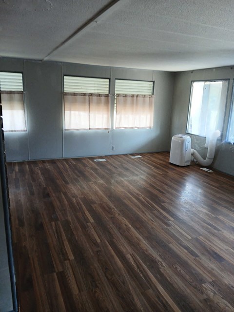 A room with wooden floors and white walls.