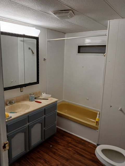 A bathroom with a sink, toilet, and bathtub.