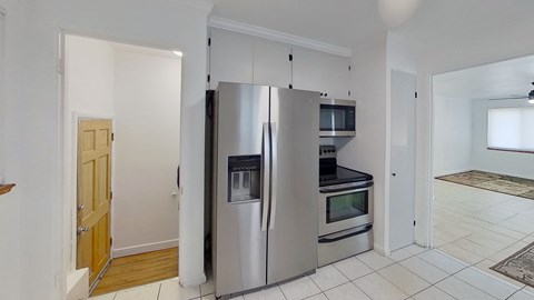 a kitchen with a stainless steel refrigerator and microwave