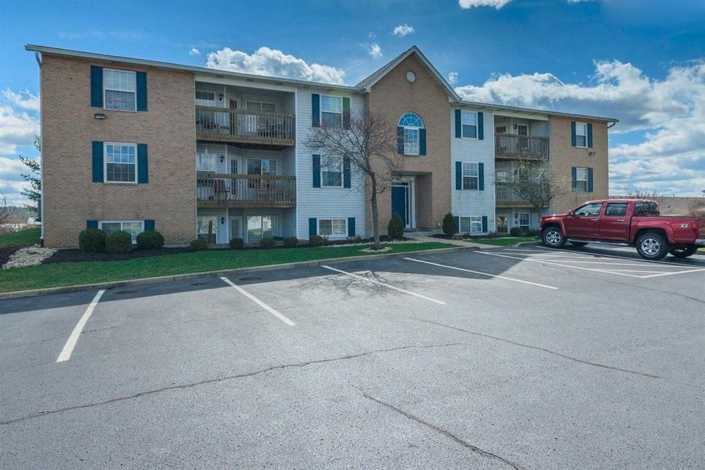 an apartment building with a red truck parked in front of it