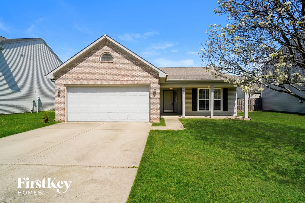 A house with a garage door is for sale by FirstKey Homes.