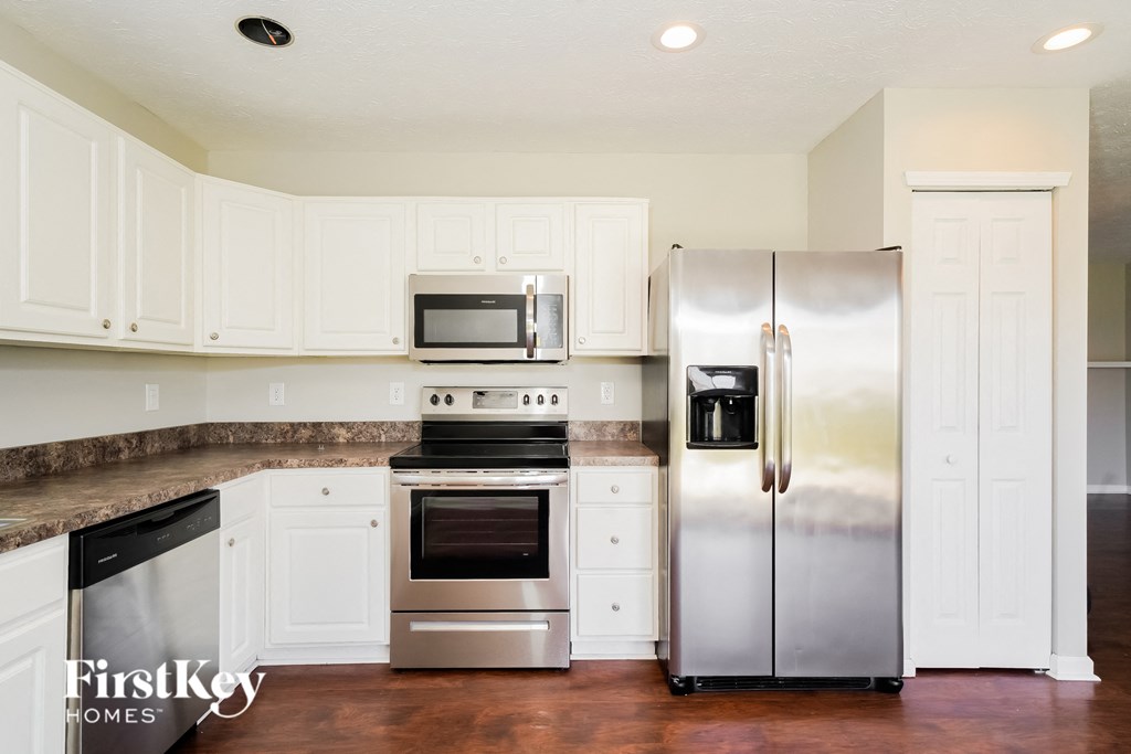A kitchen with a stainless steel refrigerator and oven.