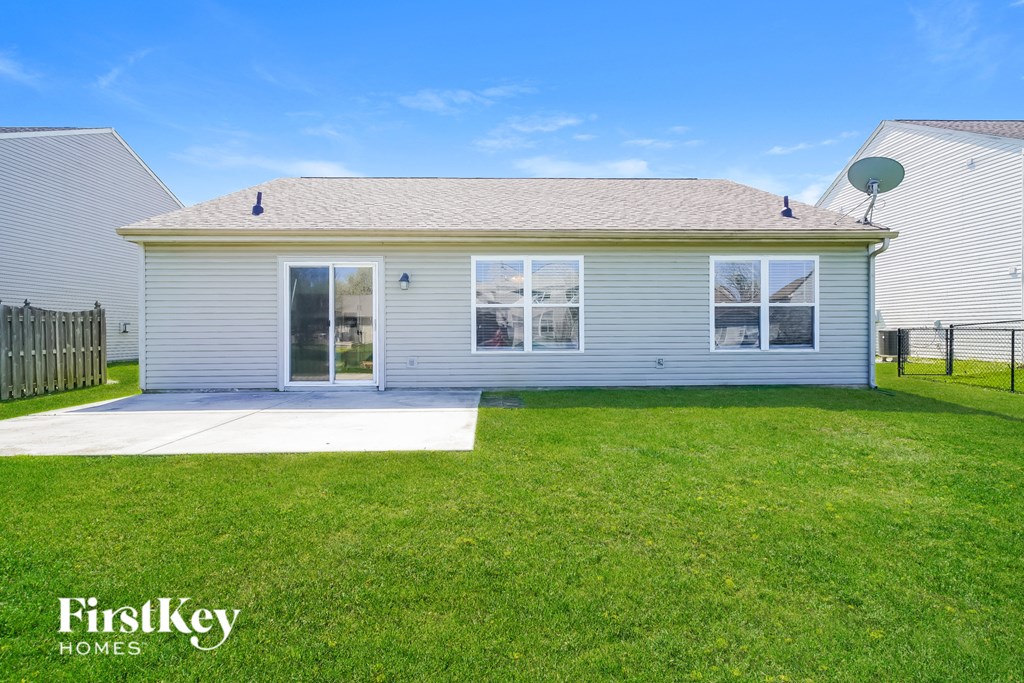 A house with a lawn in front of it.