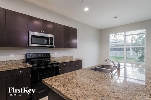 a kitchen with a granite counter top and a sink
