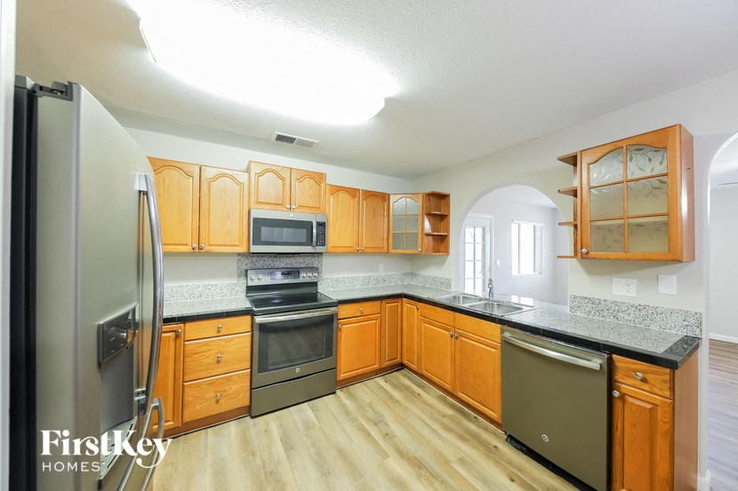 a kitchen with wooden cabinets and stainless steel appliances